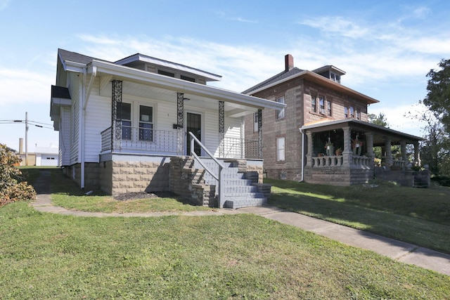 view of front of home with a porch and a front lawn