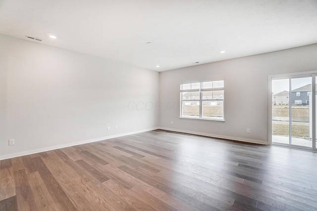 spare room featuring recessed lighting, visible vents, baseboards, and wood finished floors