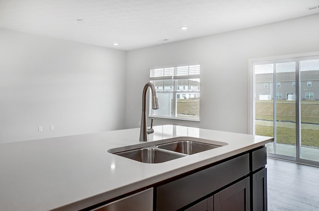 kitchen featuring light wood-type flooring, visible vents, a sink, recessed lighting, and light countertops