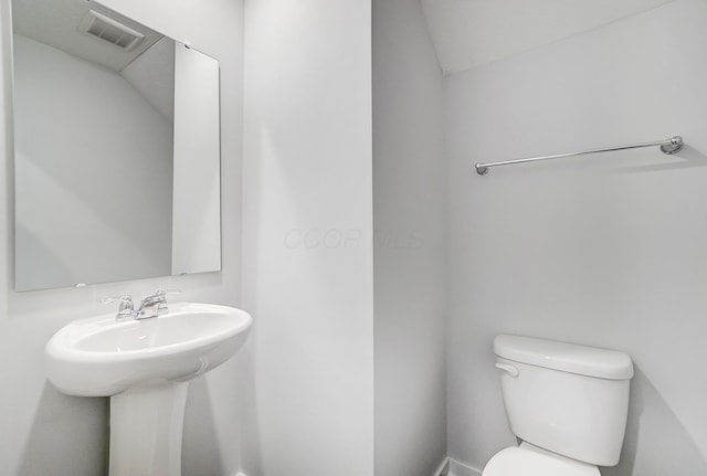 bathroom featuring visible vents and toilet