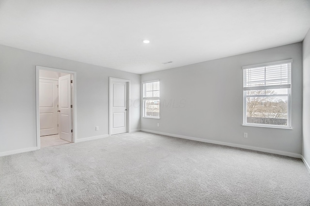 unfurnished bedroom featuring carpet flooring, visible vents, and baseboards