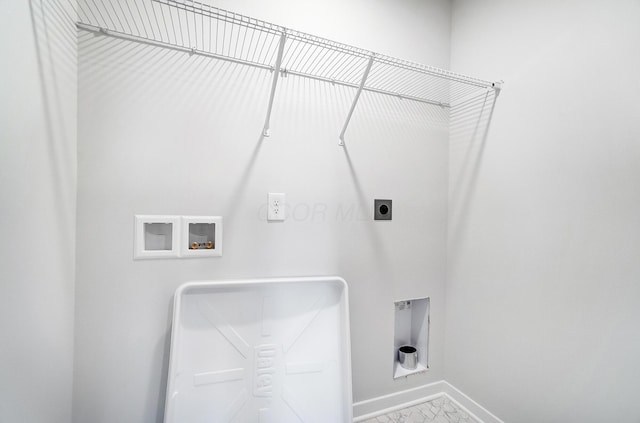 laundry area featuring baseboards, washer hookup, laundry area, marble finish floor, and hookup for an electric dryer