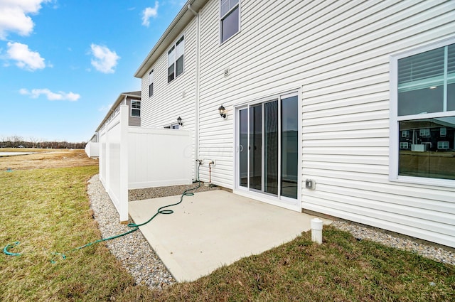 rear view of property with a patio and a lawn