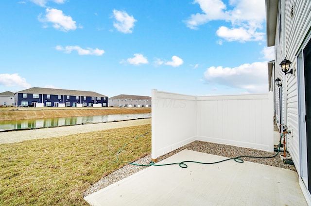 view of patio / terrace with a water view and a residential view