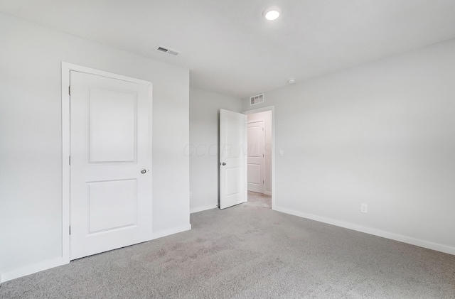 unfurnished bedroom featuring recessed lighting, visible vents, baseboards, and carpet