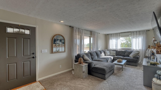 living room with a textured ceiling, light colored carpet, and an AC wall unit