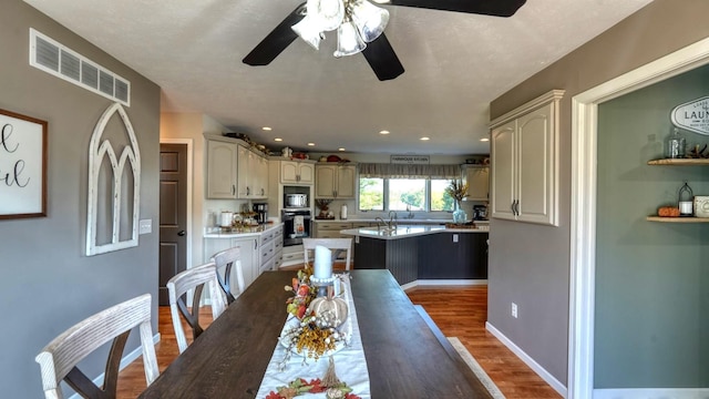 dining space featuring dark hardwood / wood-style floors and ceiling fan