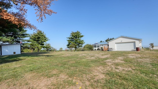 view of yard featuring a garage and an outdoor structure