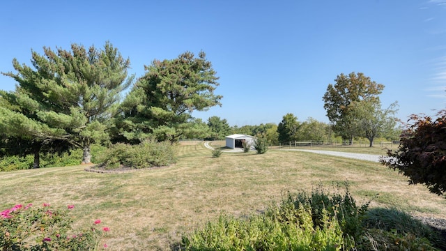 view of yard with an outbuilding and a rural view