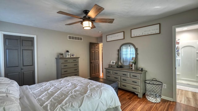 bedroom featuring ensuite bath, ceiling fan, a closet, and hardwood / wood-style floors