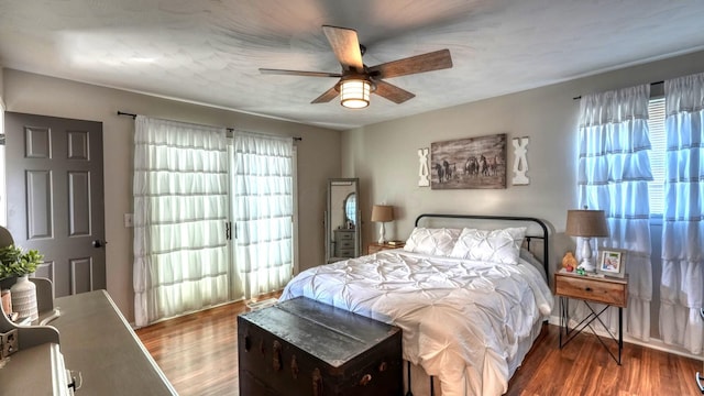 bedroom with ceiling fan and hardwood / wood-style flooring