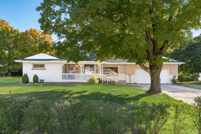 ranch-style home featuring covered porch, a garage, and a front lawn