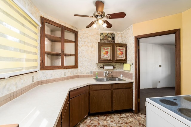 kitchen featuring electric range, sink, and ceiling fan