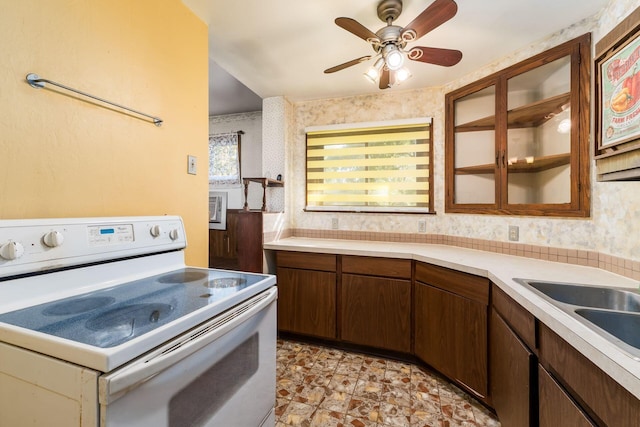 kitchen with ceiling fan, sink, and white electric stove