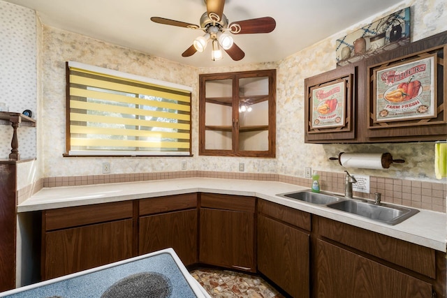 kitchen with tasteful backsplash, ceiling fan, and sink