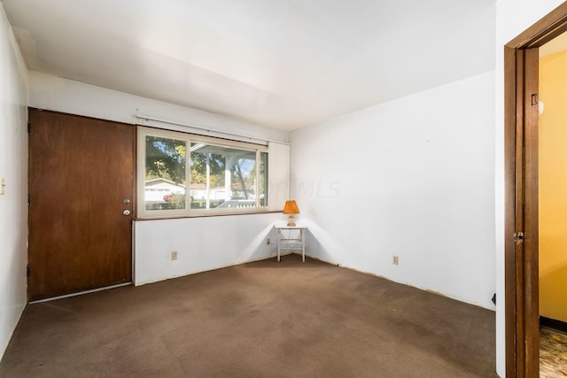 empty room with dark carpet