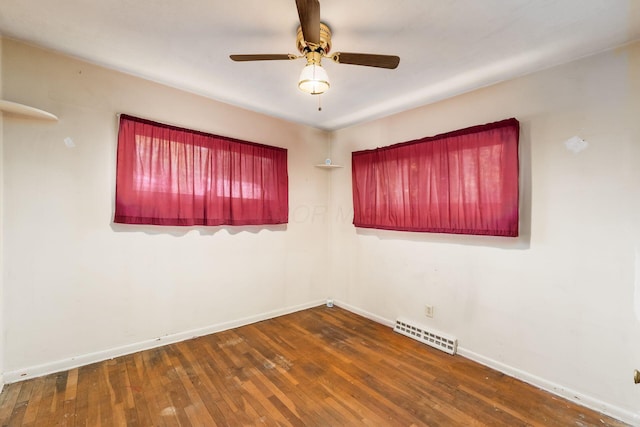 unfurnished room with ceiling fan and dark wood-type flooring