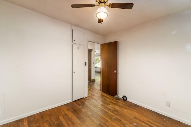 unfurnished room with ceiling fan and dark hardwood / wood-style floors