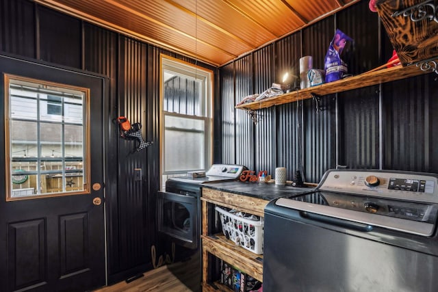 washroom featuring washer and clothes dryer, hardwood / wood-style floors, and wooden ceiling