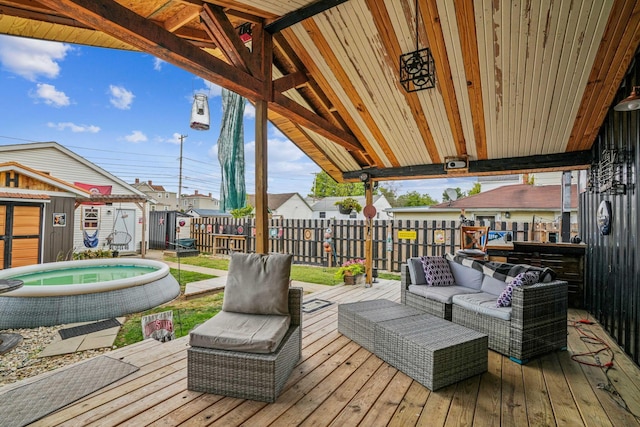 deck with an outdoor living space and a storage shed