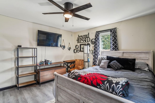 bedroom with hardwood / wood-style flooring and ceiling fan