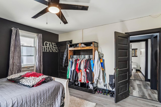 bedroom with connected bathroom, ceiling fan, a closet, and wood-type flooring