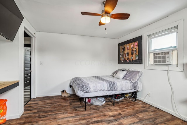 bedroom with ceiling fan, cooling unit, and dark hardwood / wood-style floors