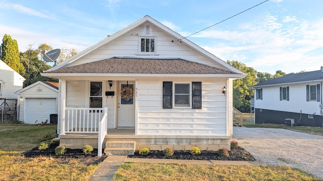 bungalow-style house with an outbuilding, a garage, and central AC unit