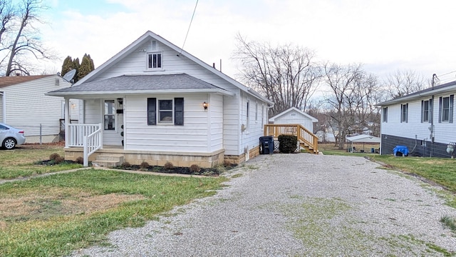 bungalow-style home with a front lawn