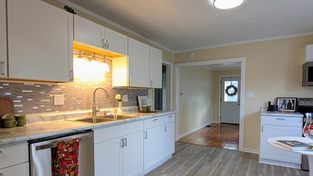 kitchen featuring white cabinetry, sink, stainless steel appliances, crown molding, and light hardwood / wood-style floors