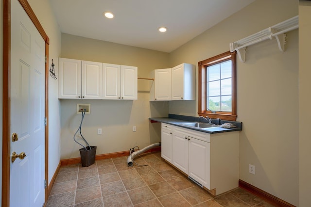 laundry room with washer hookup, cabinets, light tile patterned floors, and sink