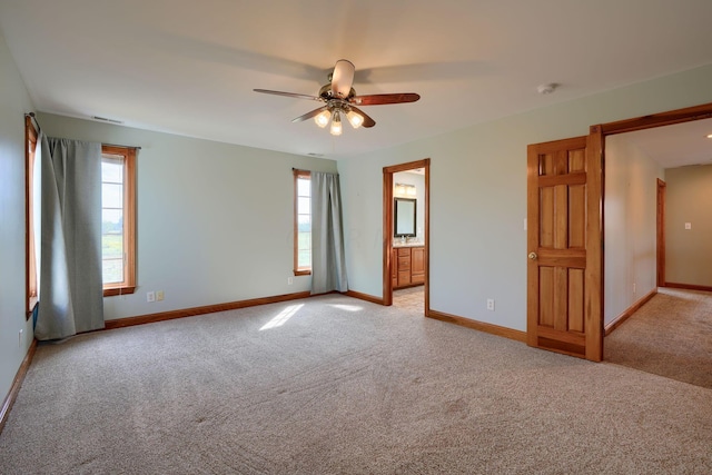 unfurnished room with ceiling fan and light carpet