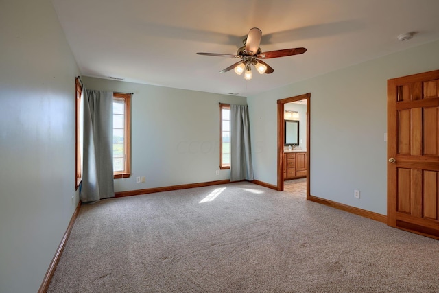 empty room with light carpet, ceiling fan, and a healthy amount of sunlight