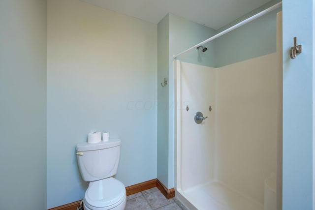 bathroom with walk in shower, tile patterned floors, and toilet