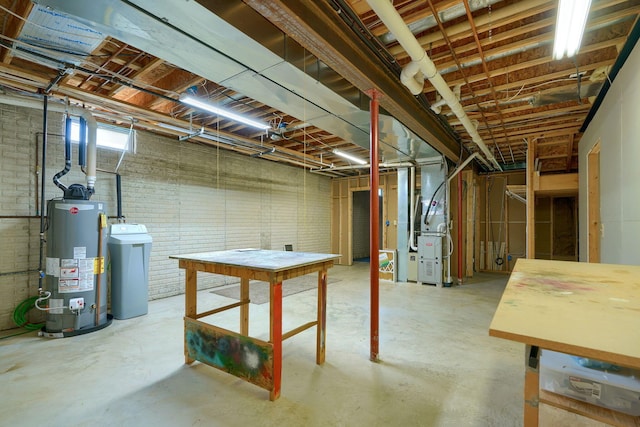 basement with brick wall, heating unit, and water heater