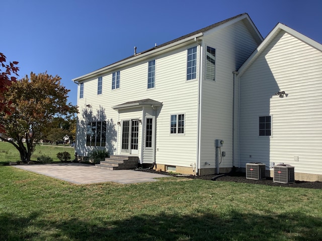 back of property featuring a lawn, a patio area, and central air condition unit