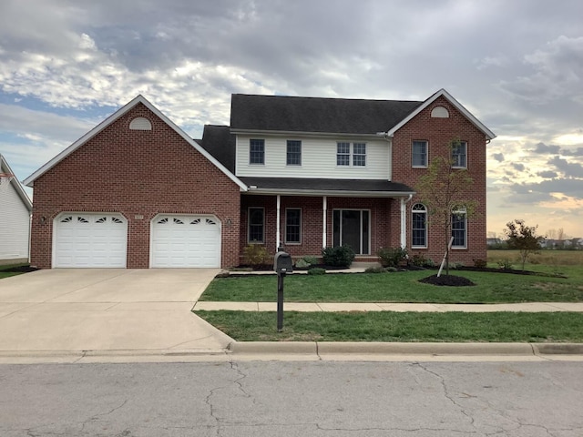 view of front facade featuring a front yard, a porch, and a garage