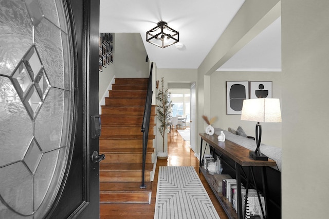 foyer featuring dark hardwood / wood-style flooring and an inviting chandelier