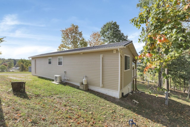 view of side of property with a yard