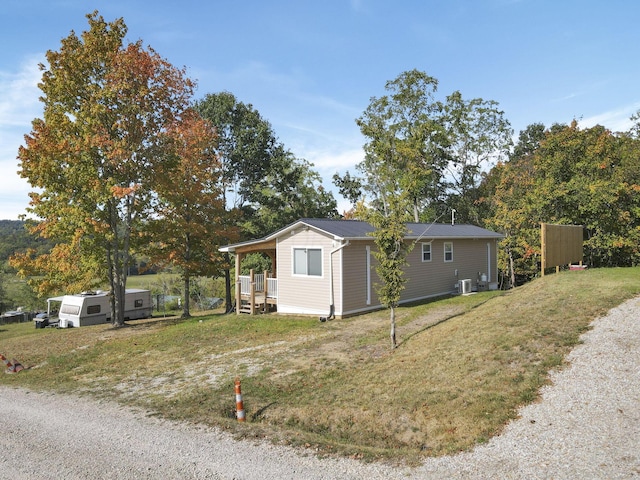 view of front of home featuring central AC and a front lawn