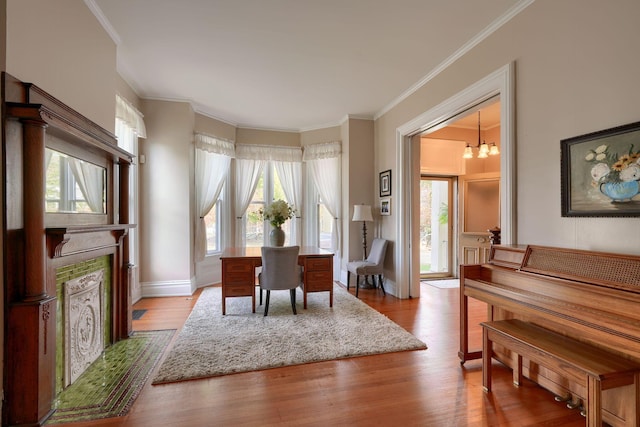 dining space with light hardwood / wood-style flooring, a wealth of natural light, and ornamental molding