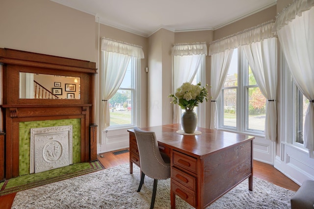 home office with crown molding and light wood-type flooring