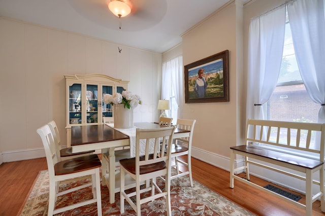 dining area featuring hardwood / wood-style floors, ceiling fan, and ornamental molding