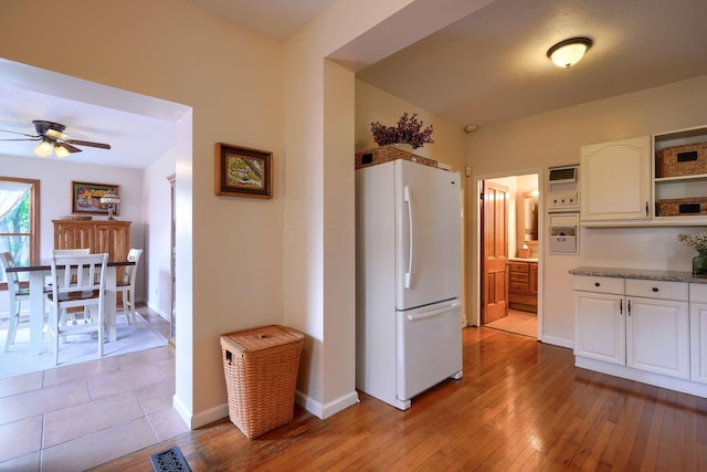 kitchen with white cabinetry, white fridge, light hardwood / wood-style floors, and ceiling fan