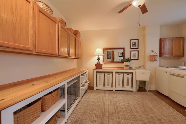 washroom featuring cabinets, ceiling fan, washing machine and dryer, and hardwood / wood-style floors