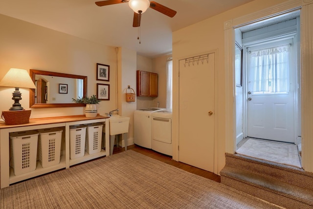 interior space with cabinets, ceiling fan, sink, light hardwood / wood-style flooring, and washing machine and dryer