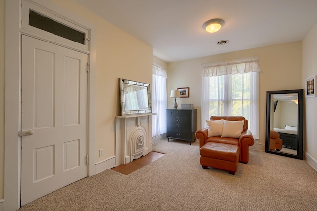 living area featuring light carpet