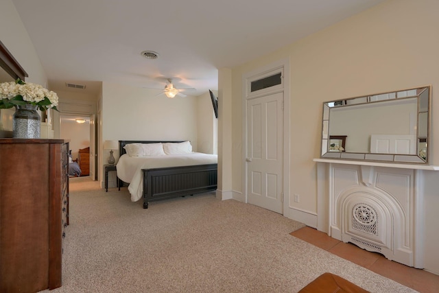 bedroom featuring light carpet and ceiling fan