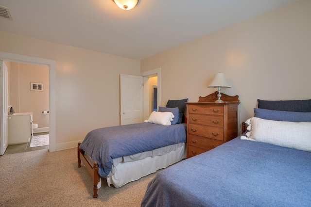 carpeted bedroom featuring ensuite bathroom