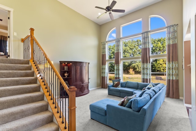 living room featuring ceiling fan, light colored carpet, and high vaulted ceiling